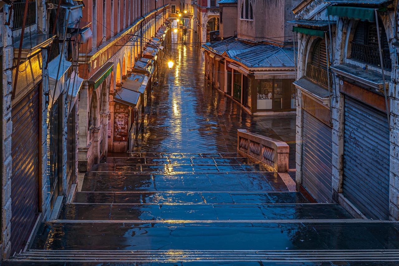 Nighttime canal scene in Venice with reflections