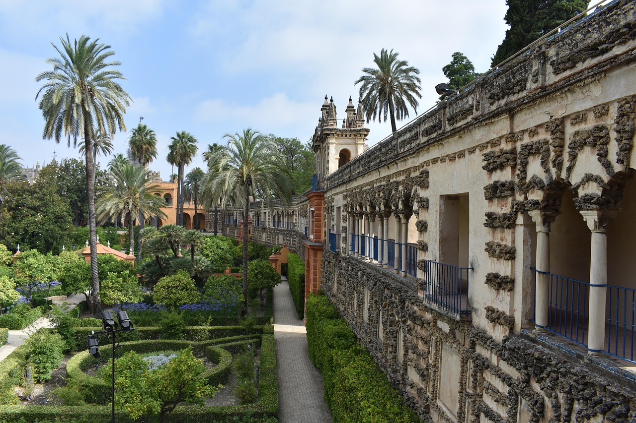 Lush gardens and palace arches at Real Alcázar of Seville
